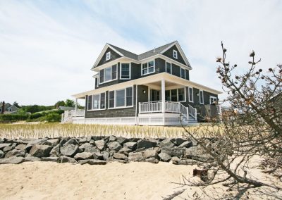 North Fork beachfront home with wraparound porch and beach grass — protected with natural tick control.