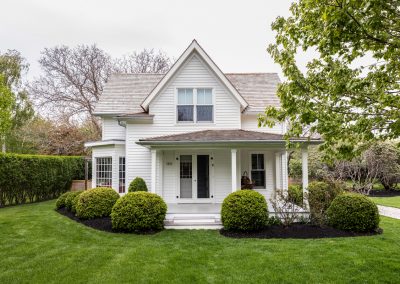 Classic white Orient farmhouse with tidy hedged lawn — the kind of North Fork property The Tick Crew treats with all-natural tick control.